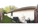 The side of this home's exterior features a gray air conditioner, dark framed window, and white wall at 7618 Majestic Pine Ct, Orlando, FL 32819