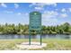 A sign at Shadow Bay Park's fishing point outlines fishing rules and hours, 8AM-8PM at 7618 Majestic Pine Ct, Orlando, FL 32819