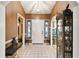 Spacious foyer with tile flooring and a decorative front door at 7618 Majestic Pine Ct, Orlando, FL 32819