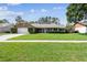 Charming brick ranch home with a lush green lawn and well-maintained landscaping at 7618 Majestic Pine Ct, Orlando, FL 32819