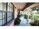 Inviting front porch with brick exterior, columns, and landscaped surroundings at 7618 Majestic Pine Ct, Orlando, FL 32819