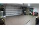 Well-lit garage features a finished floor and plenty of space for vehicles and storage at 7618 Majestic Pine Ct, Orlando, FL 32819