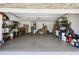 Spacious two-car garage with ample storage and durable epoxy flooring at 7618 Majestic Pine Ct, Orlando, FL 32819