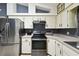 This kitchen features stainless steel appliances, neutral countertops, and white cabinets at 7618 Majestic Pine Ct, Orlando, FL 32819