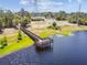Scenic lake view featuring a wooden pier perfect for outdoor enjoyment and tranquil moments at 7618 Majestic Pine Ct, Orlando, FL 32819