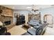 Cozy living room featuring brick fireplace, skylights, and comfortable seating arrangement at 7618 Majestic Pine Ct, Orlando, FL 32819