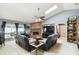 Spacious living room with vaulted ceiling, brick fireplace, skylight and comfortable seating at 7618 Majestic Pine Ct, Orlando, FL 32819