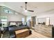 This main bedroom has a ceiling fan, a large bed and carpet floors at 7618 Majestic Pine Ct, Orlando, FL 32819