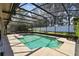 View of the expansive screened-in swimming pool with greenery behind the screen, offering a private backyard at 7618 Majestic Pine Ct, Orlando, FL 32819