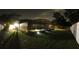 Night panoramic view of a screened pool and well-lit backyard, creating a tranquil outdoor atmosphere at 7618 Majestic Pine Ct, Orlando, FL 32819