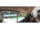 A screen-enclosed pool with a covered patio with furniture and plants at 7618 Majestic Pine Ct, Orlando, FL 32819