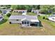 Aerial view of a full backyard, screened-in porch, healthy lawn, and fence at 8443 Sw 109Th Pl, Ocala, FL 34481