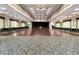 A spacious ballroom featuring elegant chandeliers, hardwood floors, and ample seating for large events at 8443 Sw 109Th Pl, Ocala, FL 34481