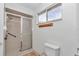This bathroom has a glass enclosed shower with a tiled surround and a window at 8443 Sw 109Th Pl, Ocala, FL 34481