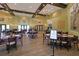 The dining area showcases wood flooring, chandeliers, and table settings, offering a pleasant atmosphere at 8443 Sw 109Th Pl, Ocala, FL 34481