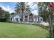 An inviting home boasts a lush green lawn and an outdoor patio area, enhanced by a towering palm tree at 8443 Sw 109Th Pl, Ocala, FL 34481