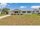 Inviting single-story home with a well-manicured lawn and a cozy front porch at 8443 Sw 109Th Pl, Ocala, FL 34481