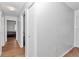 Clean hallway featuring wood floors and white walls with ample closet space at 8443 Sw 109Th Pl, Ocala, FL 34481