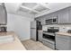 Kitchen with gray cabinets, stainless steel appliances, and tiled floors at 8443 Sw 109Th Pl, Ocala, FL 34481