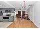 Open-concept living area seamlessly connects the kitchen and living room spaces, with hardwood flooring at 8443 Sw 109Th Pl, Ocala, FL 34481