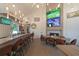 Comfortable restaurant area with multiple TVs, stylish lighting, and views of the community at 8443 Sw 109Th Pl, Ocala, FL 34481