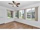 Bright sunroom featuring wood floors and large windows overlooking the backyard at 8443 Sw 109Th Pl, Ocala, FL 34481