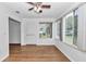 Bright sunroom with wood floors, ceiling fan, and multiple windows offering natural light at 8443 Sw 109Th Pl, Ocala, FL 34481