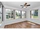 Sunroom featuring a ceiling fan and multiple windows overlooking the outdoors at 8443 Sw 109Th Pl, Ocala, FL 34481