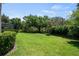 Spacious backyard with well-maintained lawn and mature trees at 8475 Eagles Loop Cir, Windermere, FL 34786