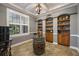 Charming bar room showcasing a wine barrel table, custom shelving, and natural light from the window at 8475 Eagles Loop Cir, Windermere, FL 34786