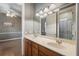 Bathroom with dual sinks, spacious vanity and a neutral color palette at 8475 Eagles Loop Cir, Windermere, FL 34786