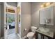 Half bath with a stylish vessel sink and access to the outdoor pool area at 8475 Eagles Loop Cir, Windermere, FL 34786