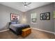 Well-lit bedroom showcasing sports memorabilia, a cozy bed, and modern ceiling fan at 8475 Eagles Loop Cir, Windermere, FL 34786