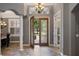 Elegant foyer with tile floors, chandelier, and a view of the front yard at 8475 Eagles Loop Cir, Windermere, FL 34786