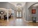 Grand foyer featuring tile flooring, decorative columns, and a stylish chandelier at 8475 Eagles Loop Cir, Windermere, FL 34786