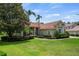 Attractive single story home with a well-maintained lawn and mature trees at 8475 Eagles Loop Cir, Windermere, FL 34786