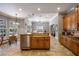 Open kitchen layout with island, stainless dishwasher, and seamless transition to dining and living spaces at 8475 Eagles Loop Cir, Windermere, FL 34786
