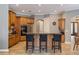 Kitchen featuring wooden cabinetry, stainless steel appliances, and a center island with breakfast bar seating at 8475 Eagles Loop Cir, Windermere, FL 34786