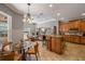 Open kitchen boasts an island, stainless appliances, and seamless transition to the living and dining areas at 8475 Eagles Loop Cir, Windermere, FL 34786