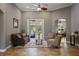 Comfortable living room with neutral tones, ceiling fan, and backyard access at 8475 Eagles Loop Cir, Windermere, FL 34786