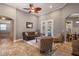 Bright living room featuring tile flooring, a ceiling fan, French doors, and comfortable seating at 8475 Eagles Loop Cir, Windermere, FL 34786