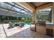 Outdoor kitchen includes grill, refrigerator, and countertops with a nice outdoor seating area at 8475 Eagles Loop Cir, Windermere, FL 34786
