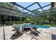 Screened-in pool and spa area with a fire pit and comfortable seating at 8475 Eagles Loop Cir, Windermere, FL 34786