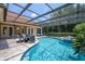 Screened-in pool with patio furniture and lush landscaping at 8475 Eagles Loop Cir, Windermere, FL 34786