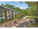 Lush backyard with a screened-in pool, outdoor seating, and mature trees at 98 Wisteria Dr, Longwood, FL 32779