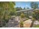Beautiful backyard featuring a screened-in pool, lush landscaping, and a stone pathway at 98 Wisteria Dr, Longwood, FL 32779