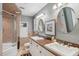 Well-lit bathroom featuring double sinks, granite countertops, and updated fixtures at 98 Wisteria Dr, Longwood, FL 32779