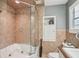 Modern bathroom features a glass-enclosed shower, tile surround, and built-in shelving at 98 Wisteria Dr, Longwood, FL 32779