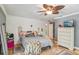 Comfortable bedroom featuring a ceiling fan, ample closet space, and neutral decor at 98 Wisteria Dr, Longwood, FL 32779