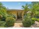 Charming front entrance with stone facade, landscaping, and a brick walkway at 98 Wisteria Dr, Longwood, FL 32779